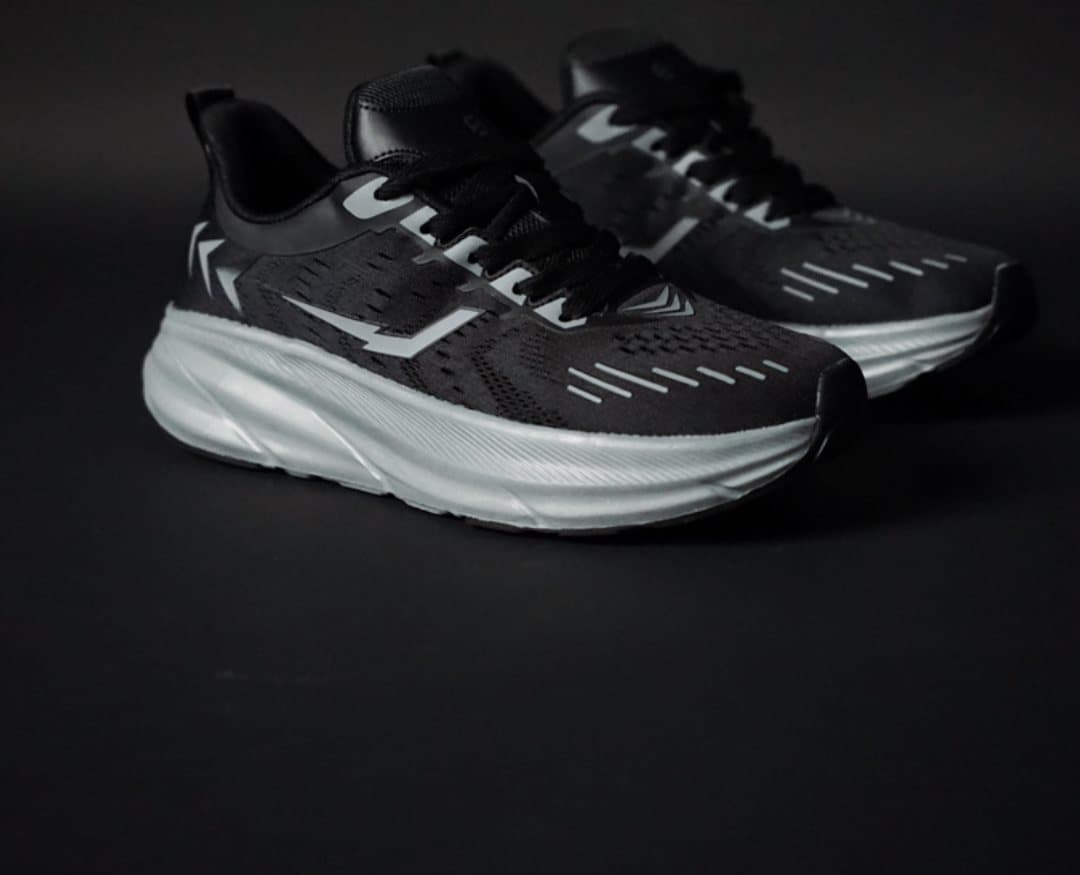 Pair of Morph Lite runners on a dark studio floor